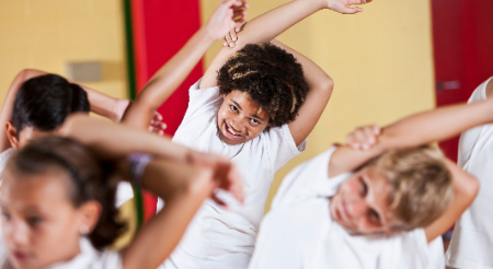 Middle school students in physical education class stretching 